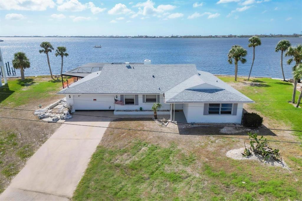 an aerial view of a house with a yard