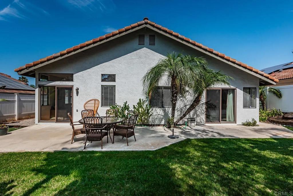 a view of a house with backyard porch and sitting area