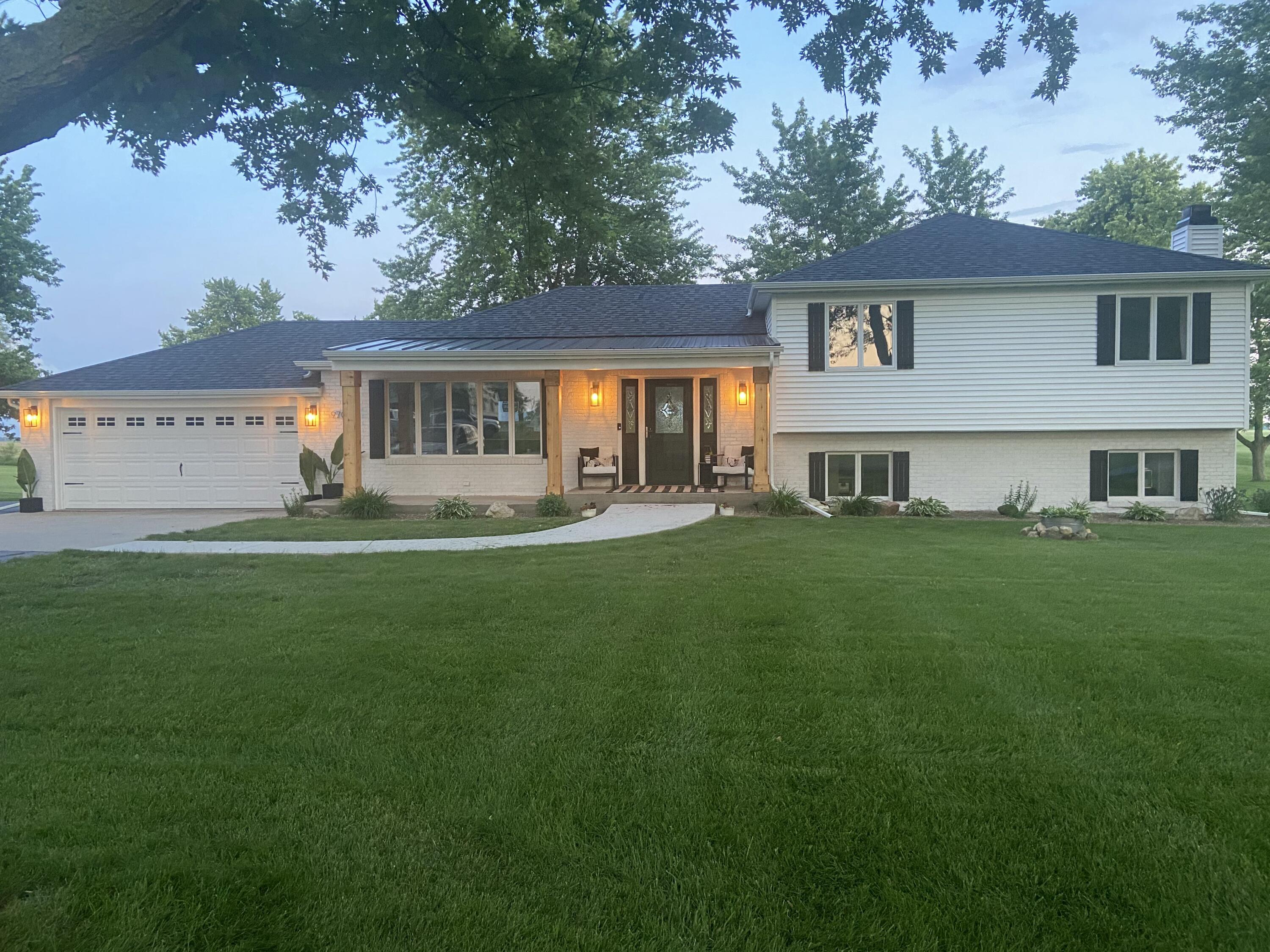 a front view of house with yard and green space