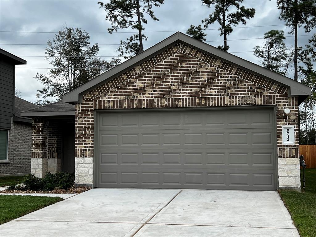 a front view of a house with garage