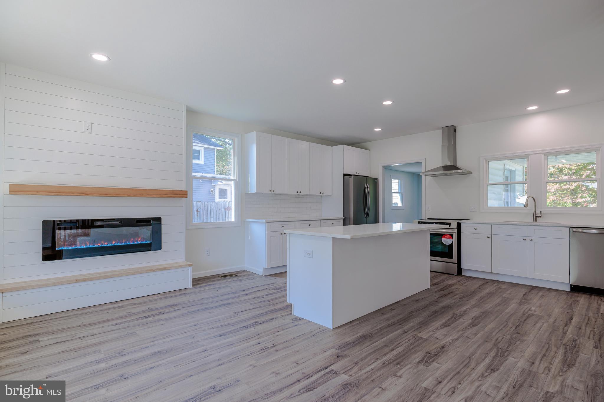 a kitchen with a hard wood floor and a refrigerator