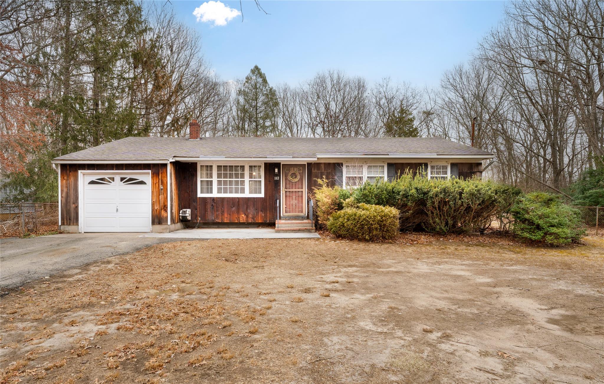 Ranch-style house featuring a garage