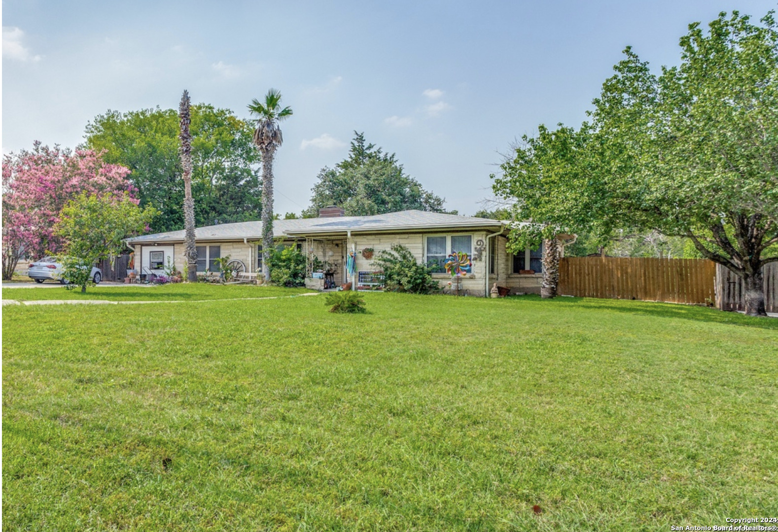 a view of house that has a yard