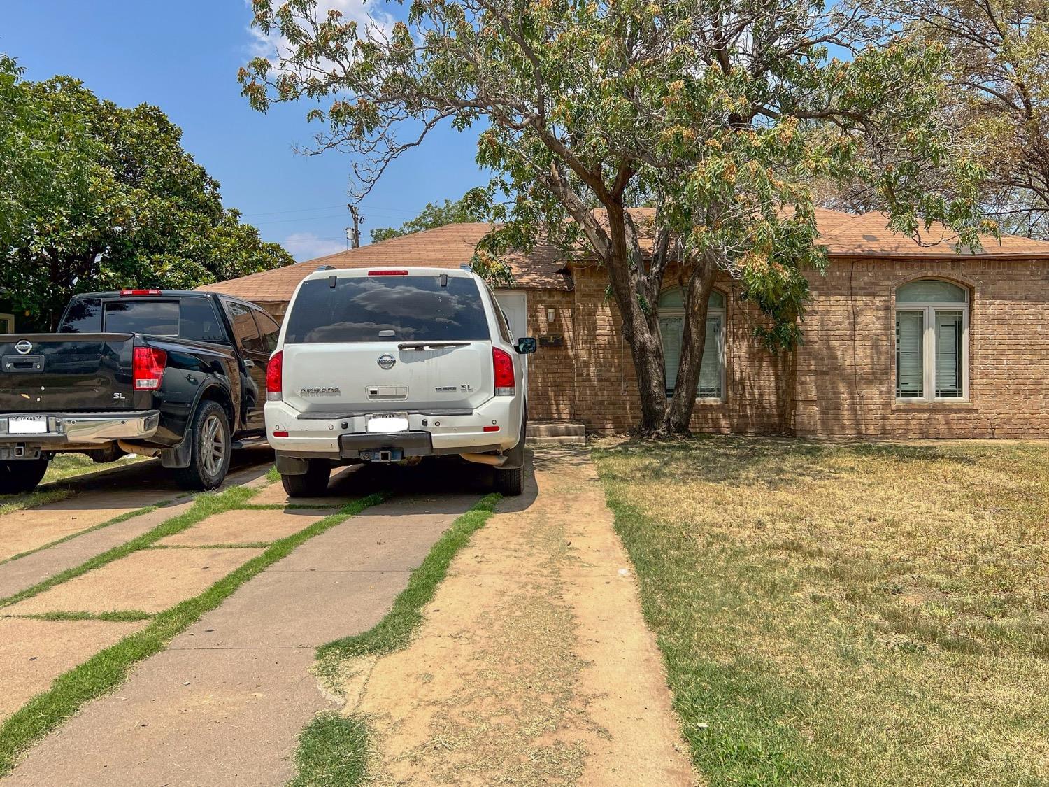 a view of car parked in parking lot of house