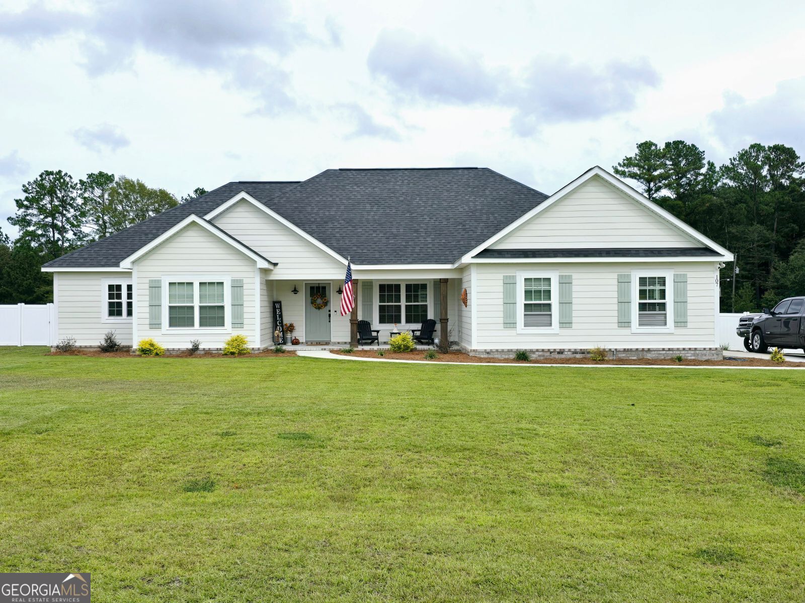 a front view of a house with a garden