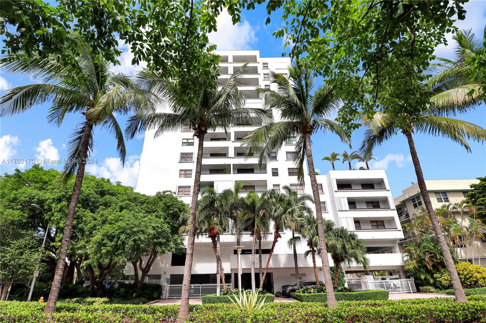 a front view of a multi story building with a yard