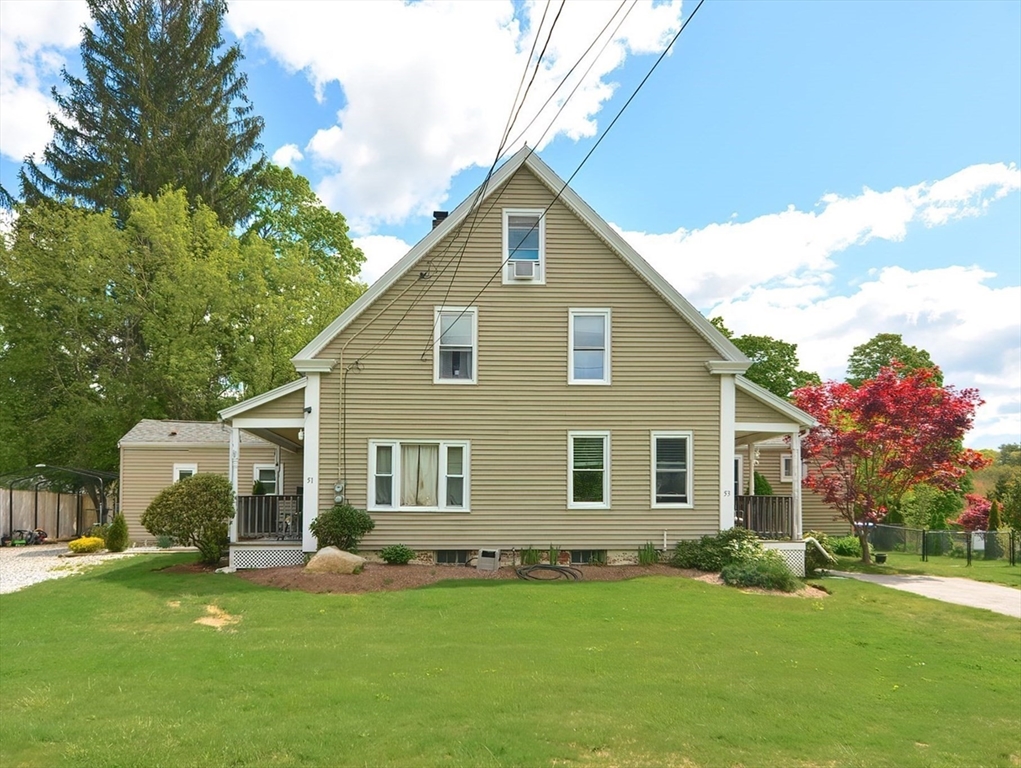 a front view of house with yard and green space