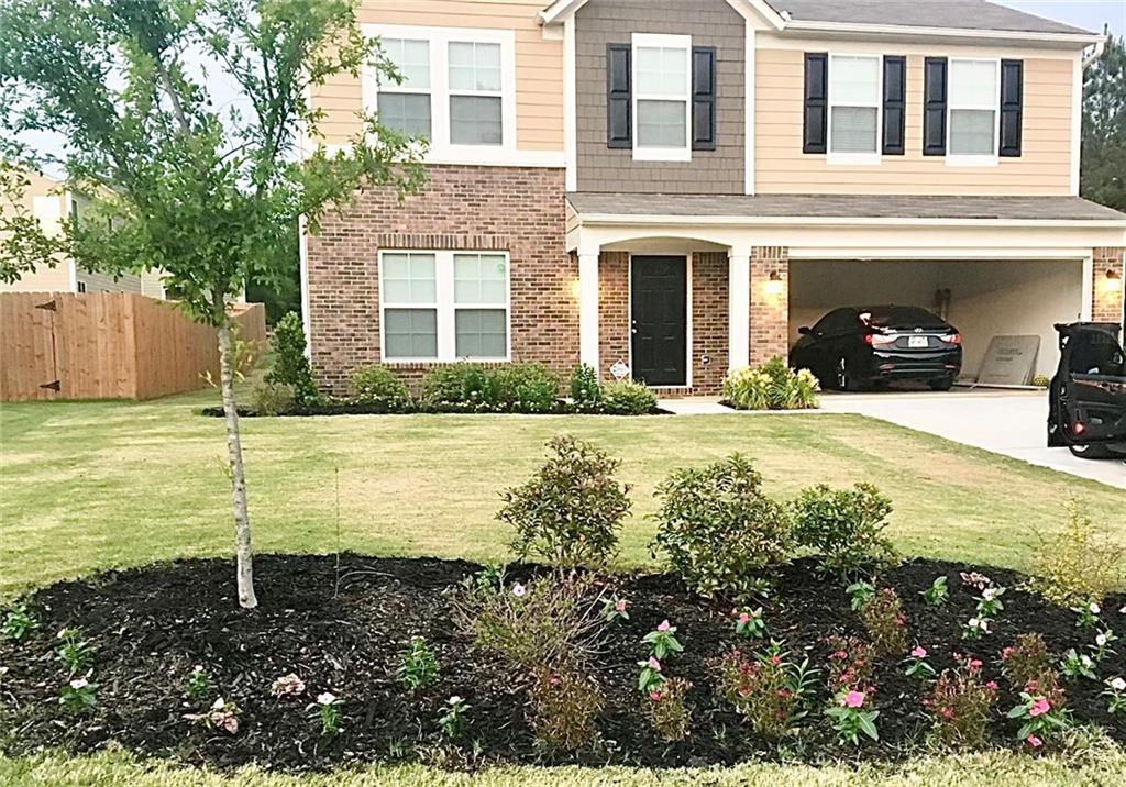 a front view of a house with a yard