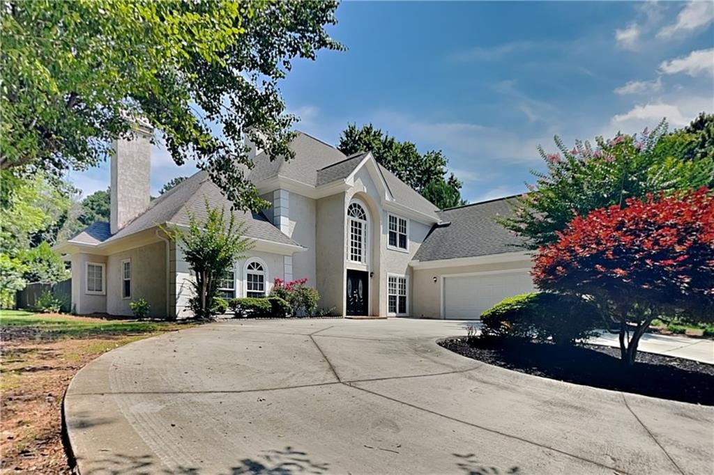 a front view of a house with a yard and a garage