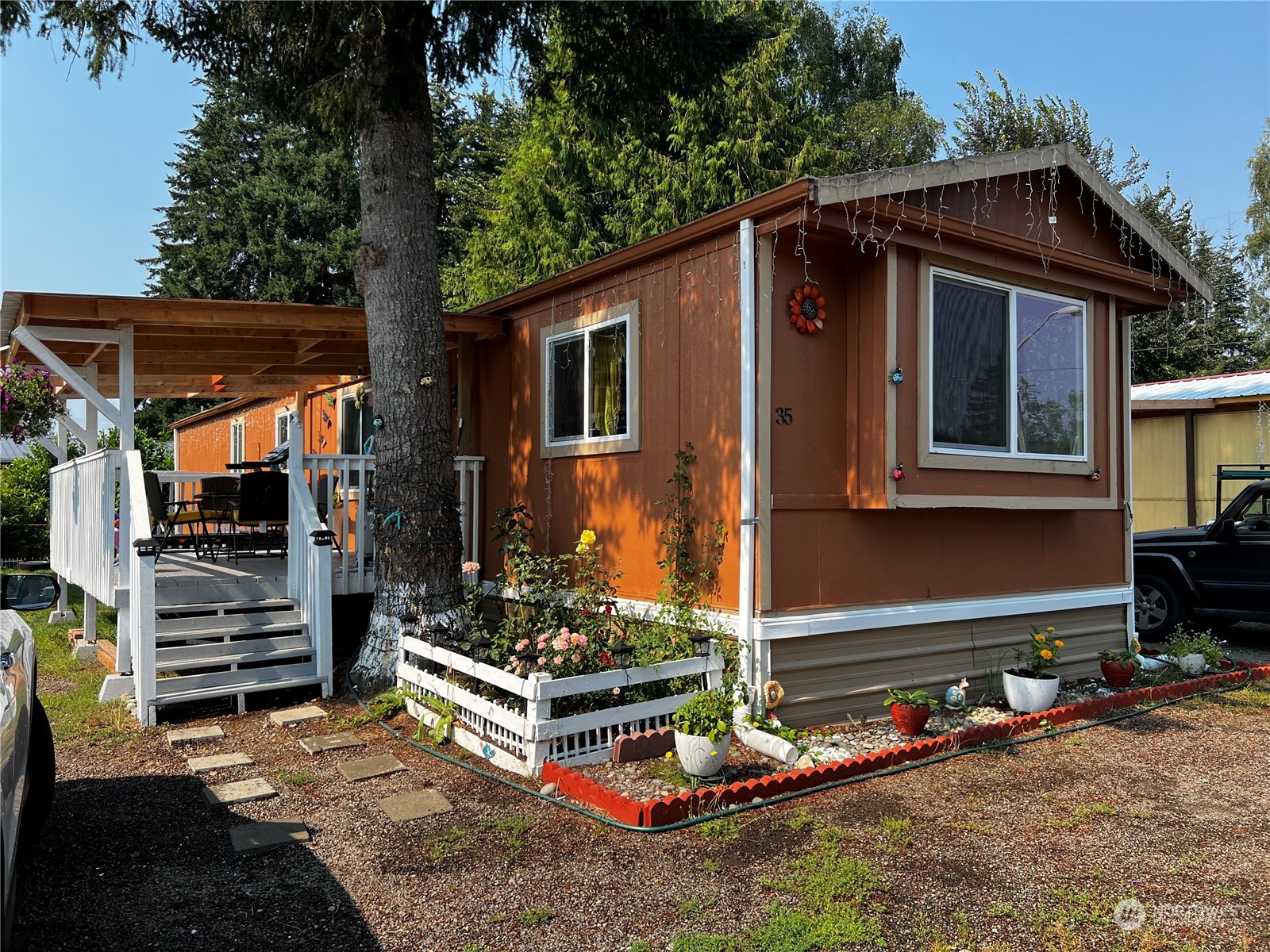 a front view of house with yard outdoor seating and barbeque oven