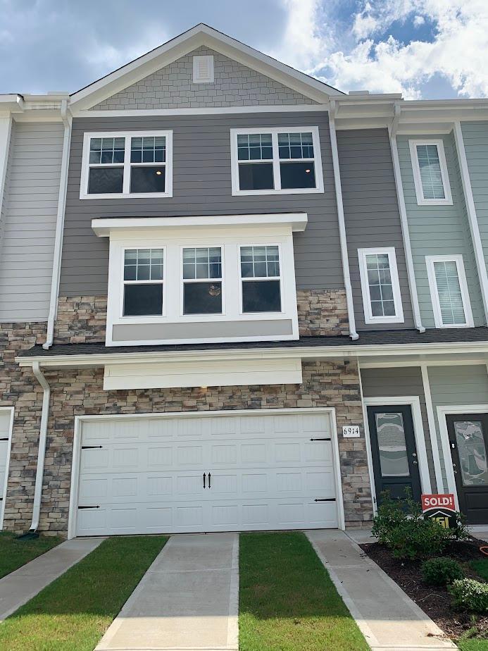 a front view of a house with yard