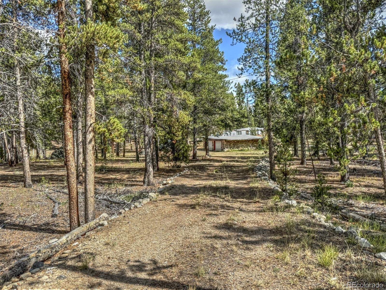 a view of a yard with wooden fence