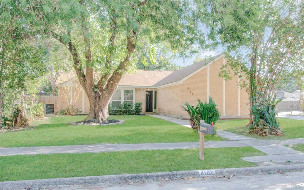 a house that has a tree in front of a house