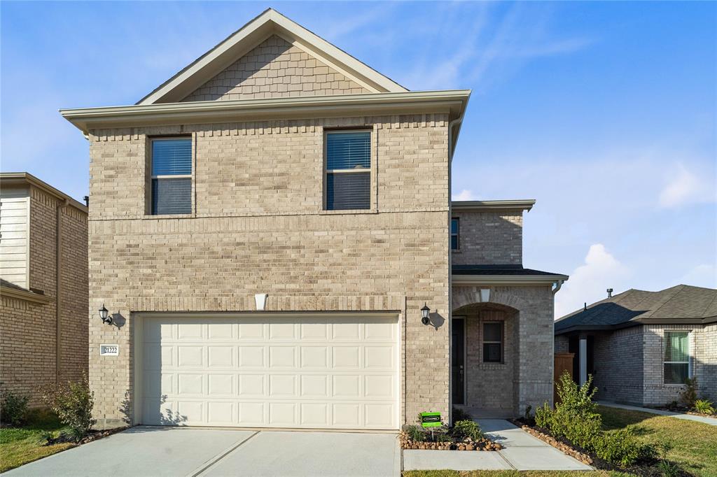 a front view of a house with garage