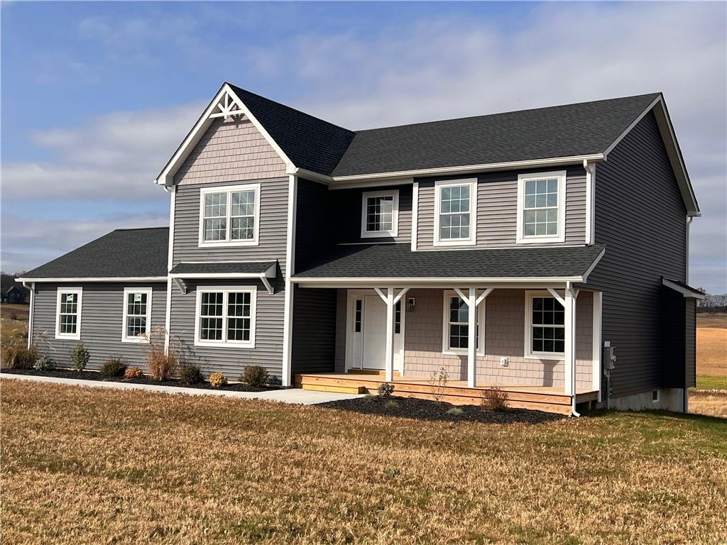 View of front facade with a front yard and a porch