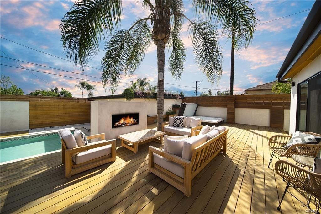 a view of a patio with couches and a fireplace