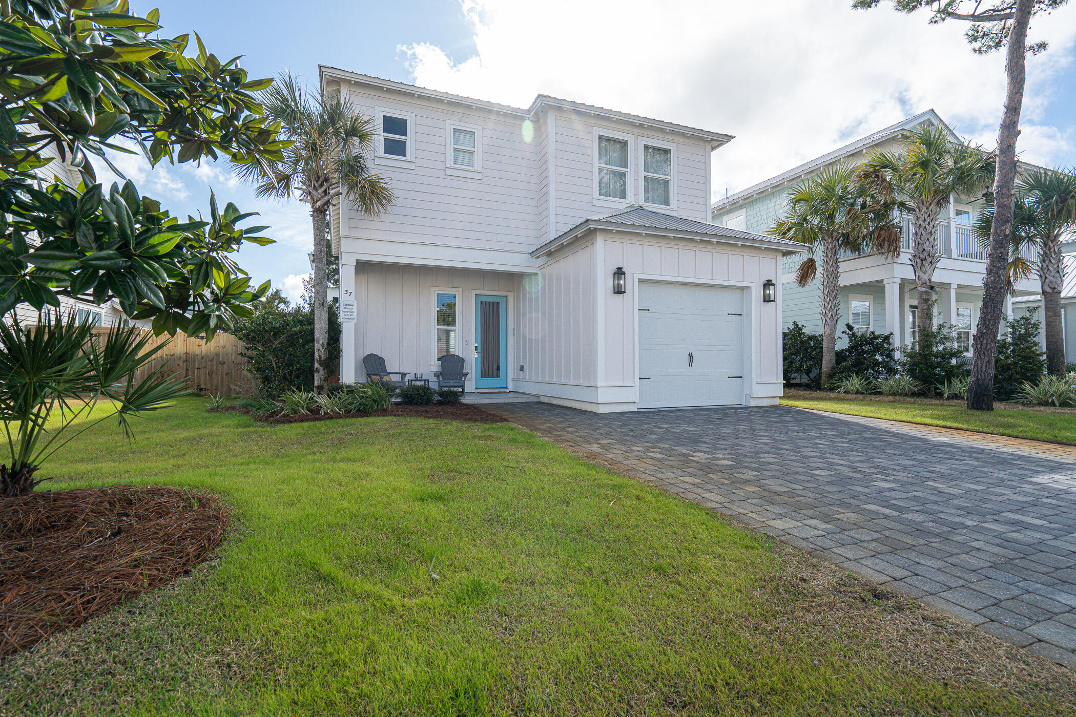 a front view of house with yard and green space