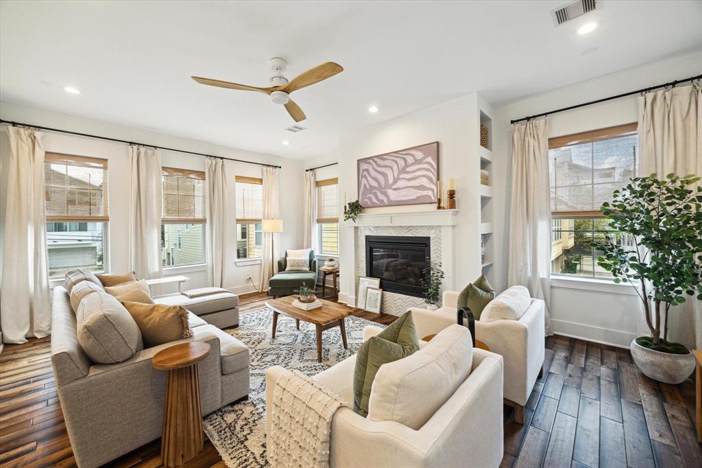 a living room with furniture a fireplace and a potted plant