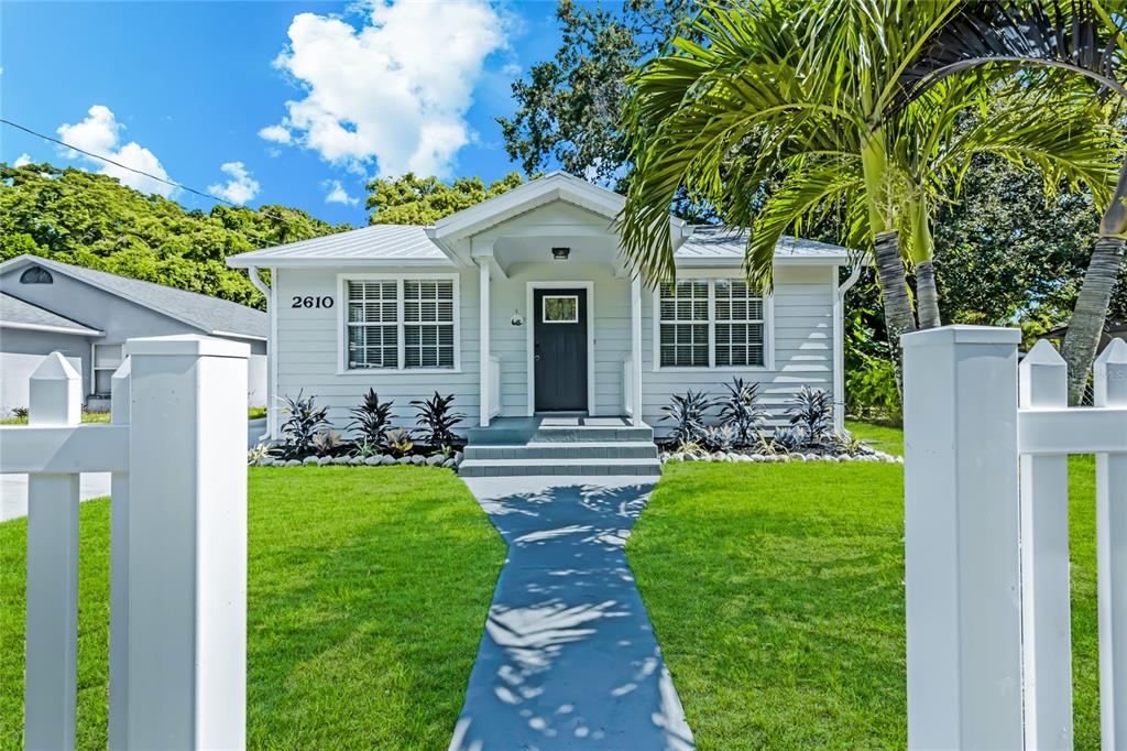 a front view of a house with garden