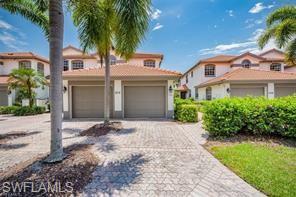 front view of house with a yard and palm trees