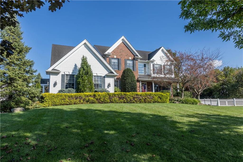 a front view of house with yard and green space