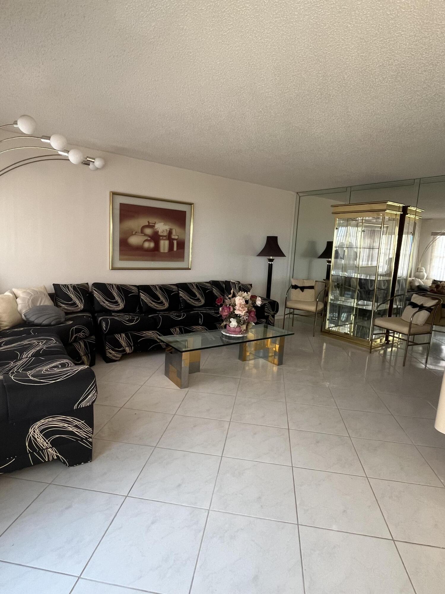 a living room with furniture a air conditioner vent and a window