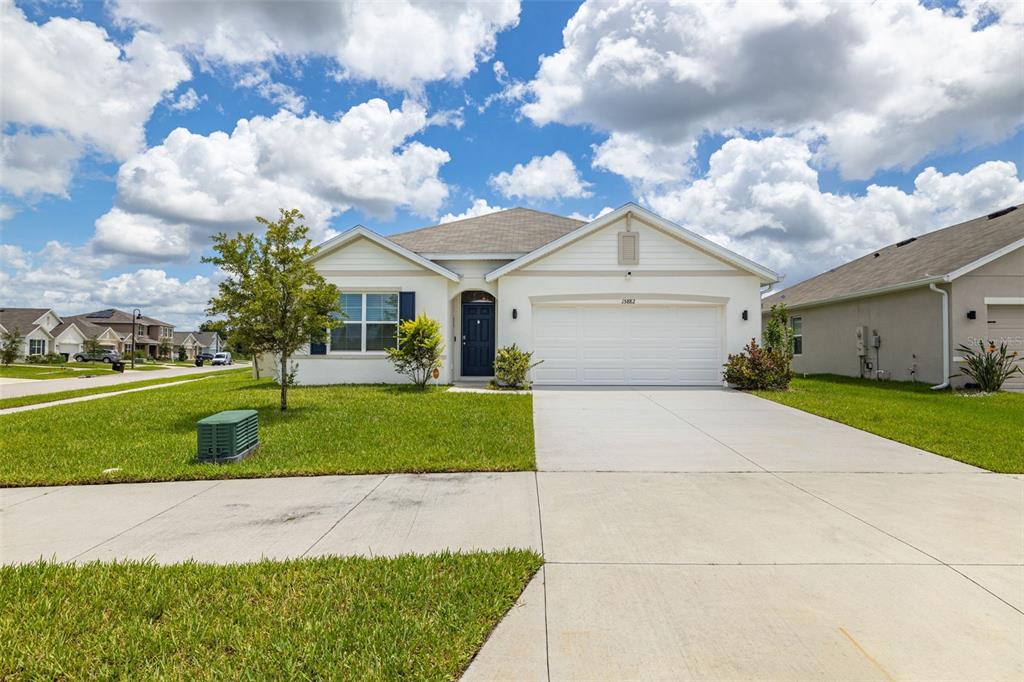 a front view of a house with a yard and garage