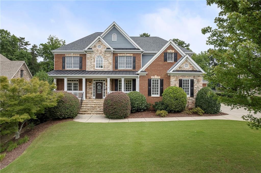 a front view of a house with a garden