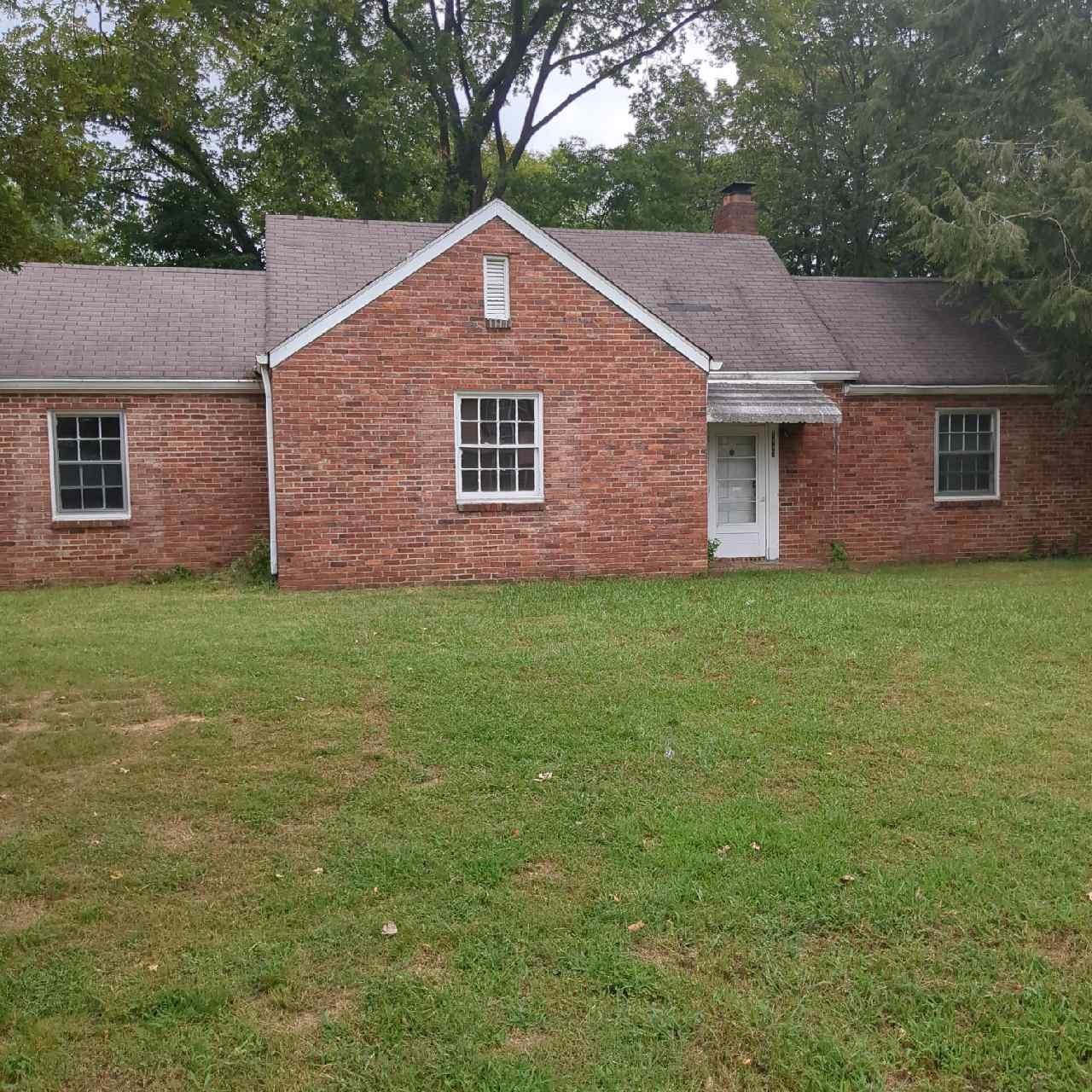 a aerial view of a house next to a yard