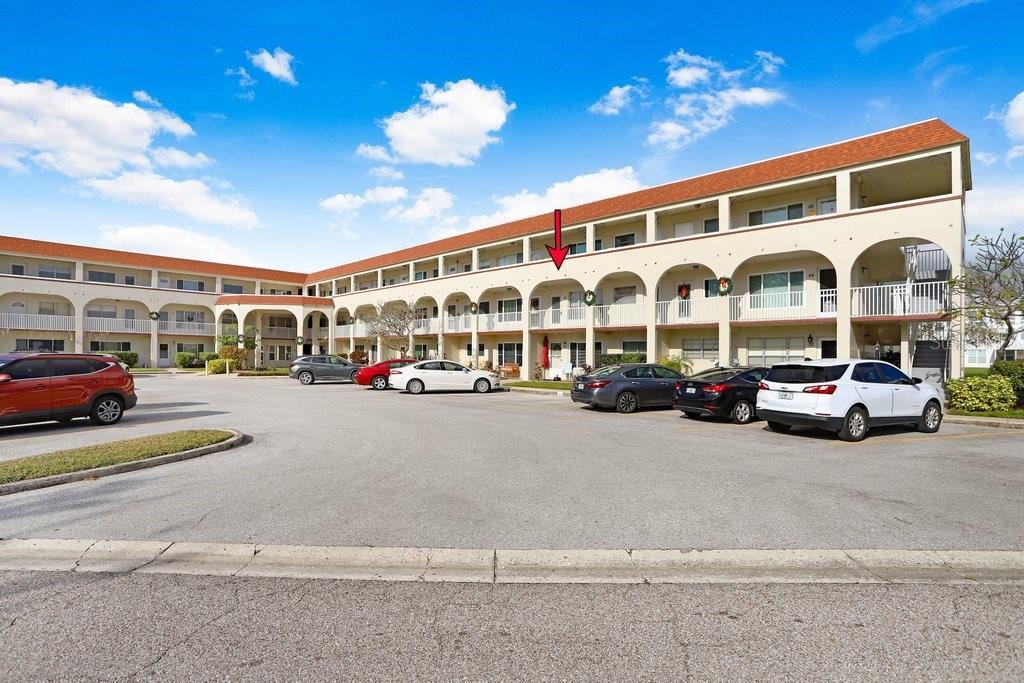 a view of a building with cars parked