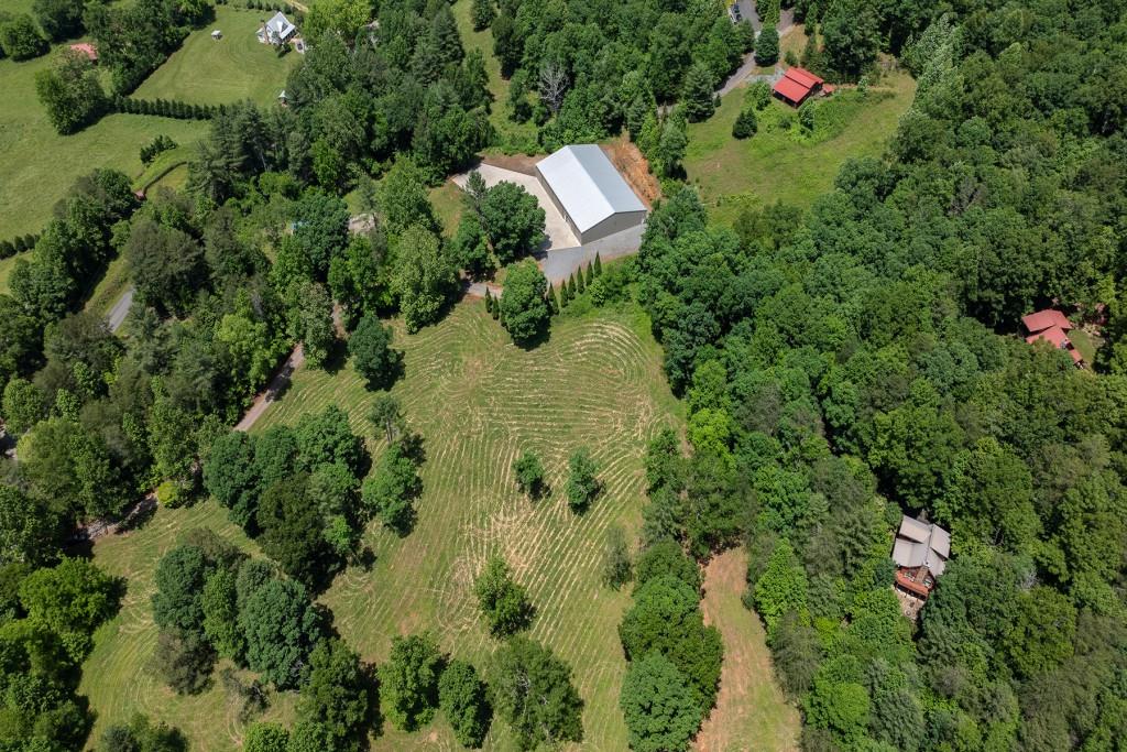 an aerial view of residential house with yard and outdoor space