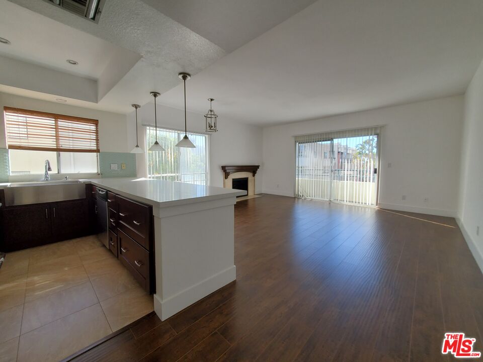 a kitchen with a sink cabinets and wooden floor