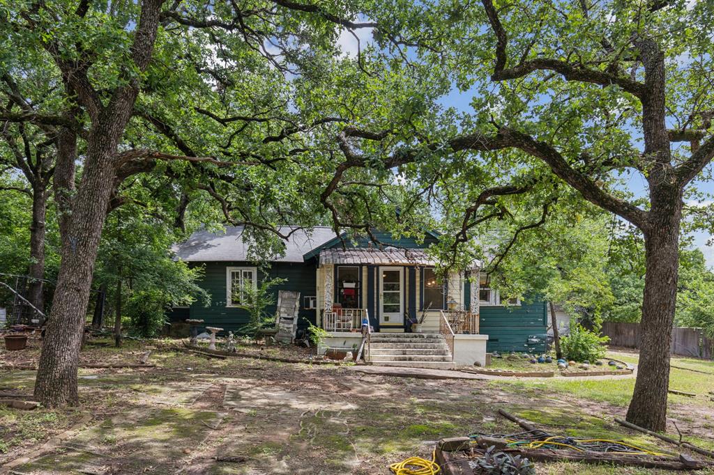 a front view of a house with sitting area and garden