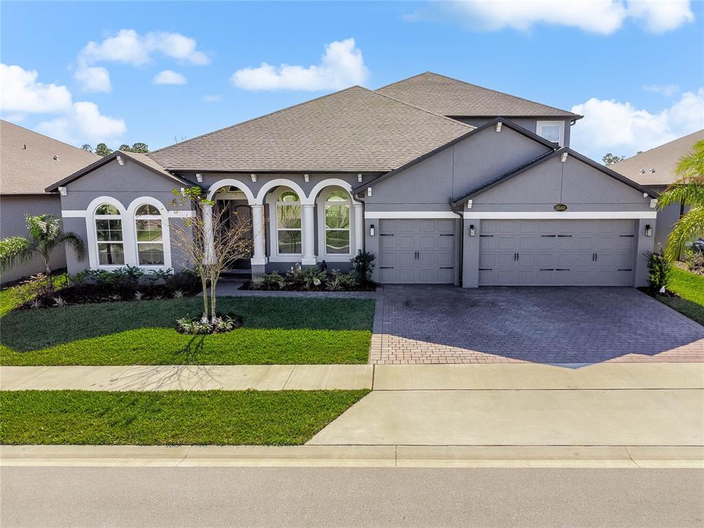 a front view of house with yard and green space