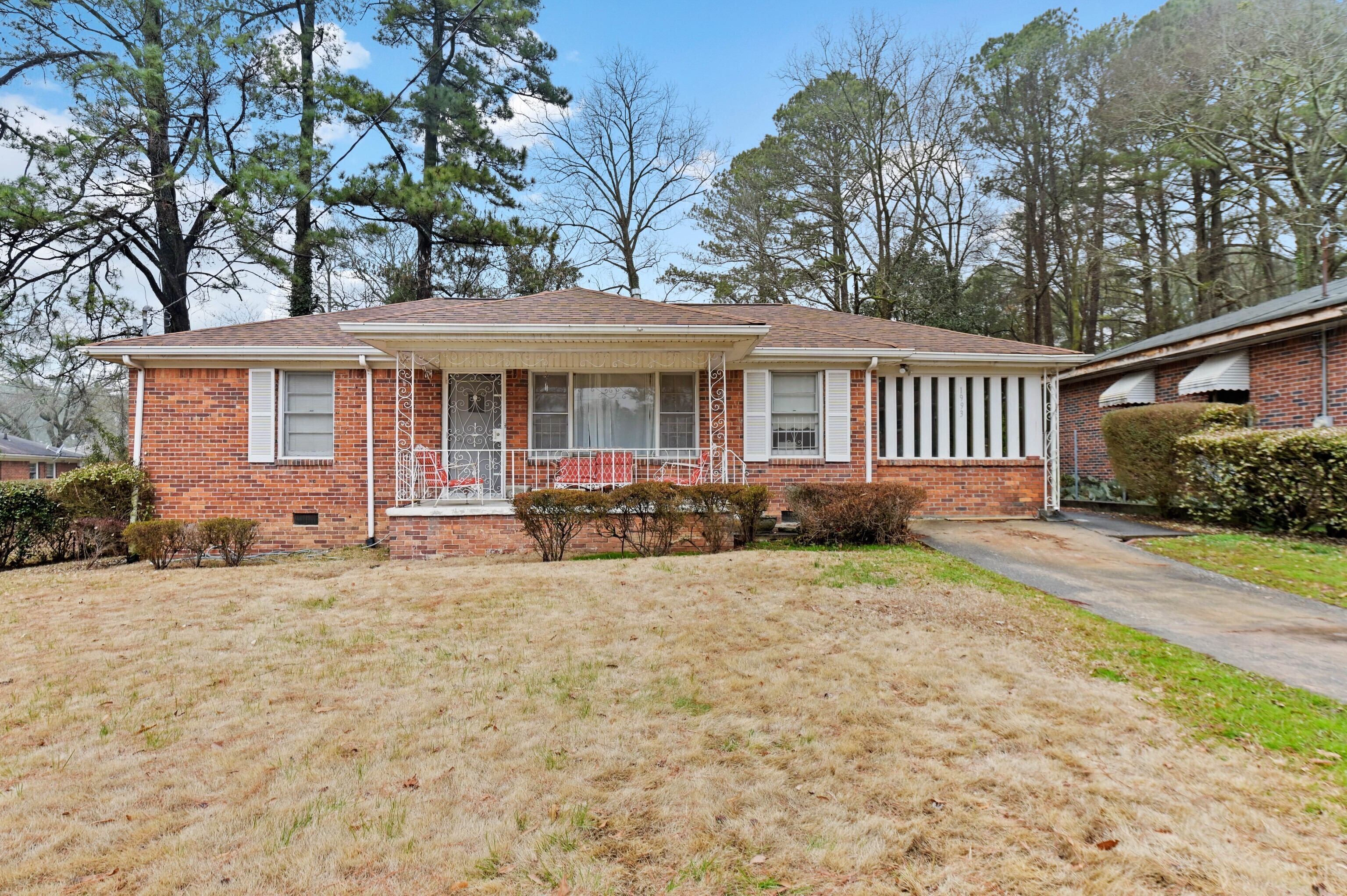 a view of a house with a yard and wooden fence