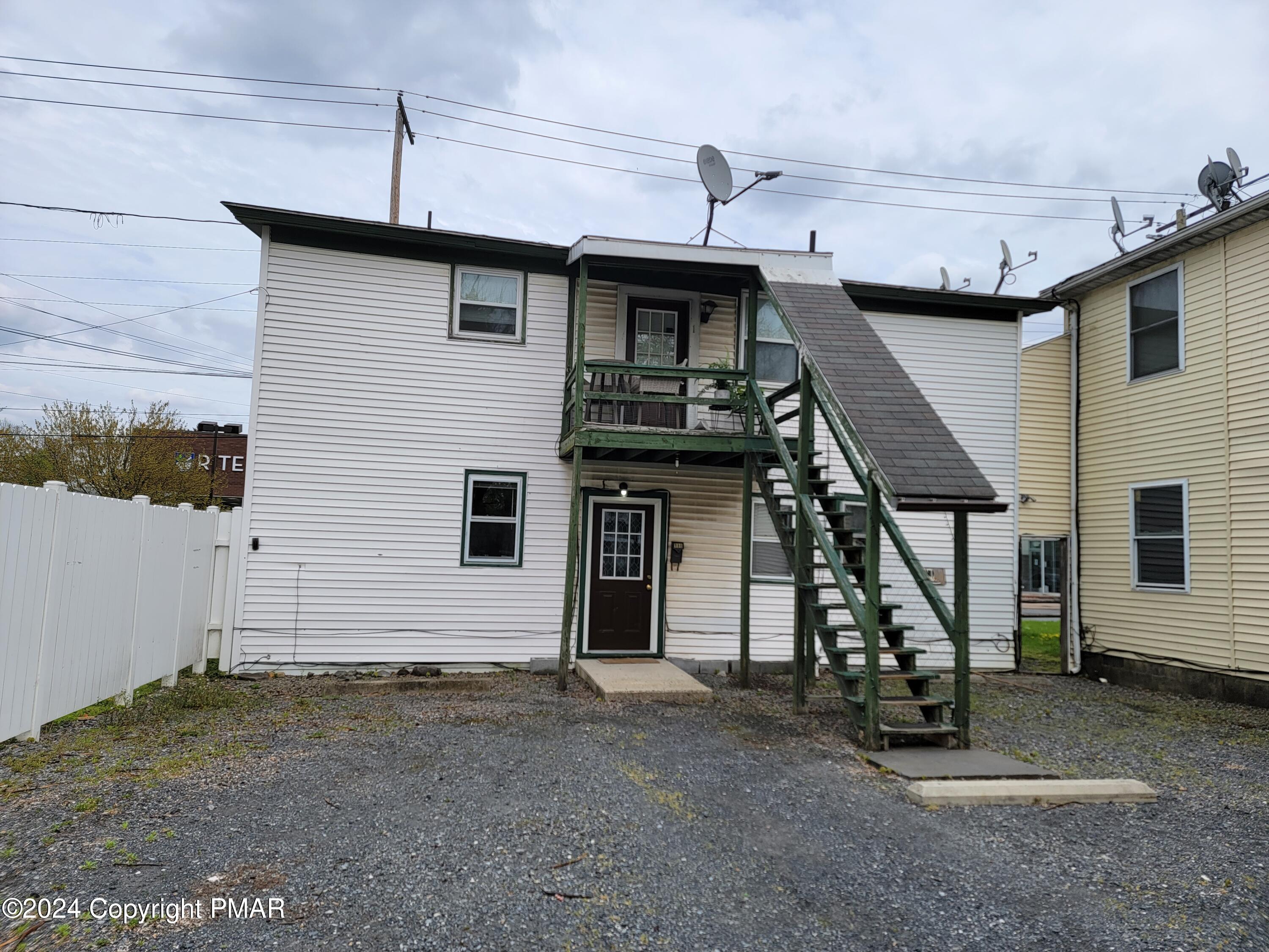 a view of a house with wooden stairs