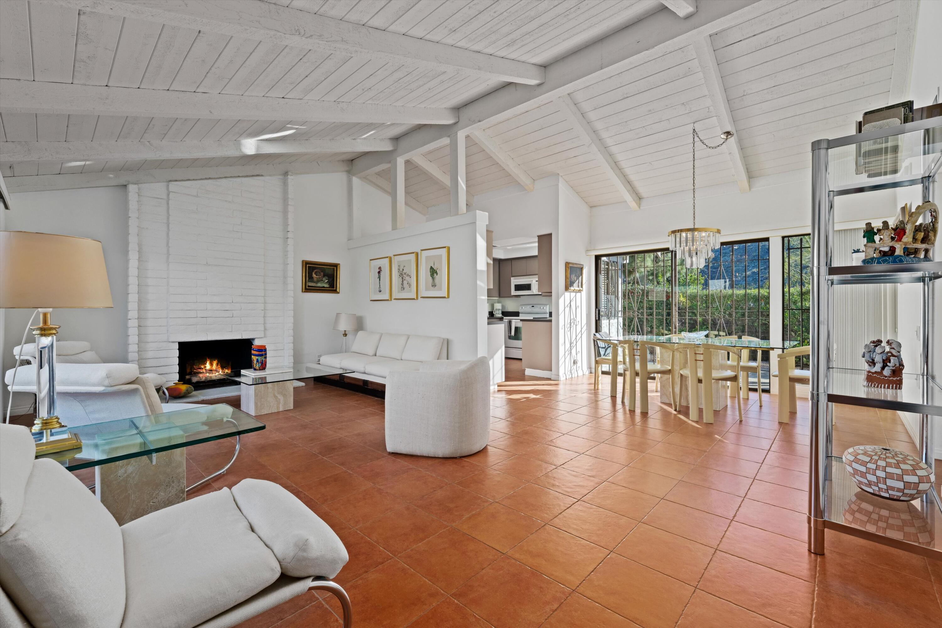 a living room with furniture a fireplace and a table