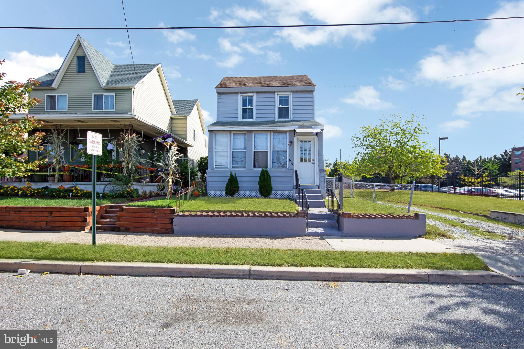 a view of a house with a big yard and potted plants