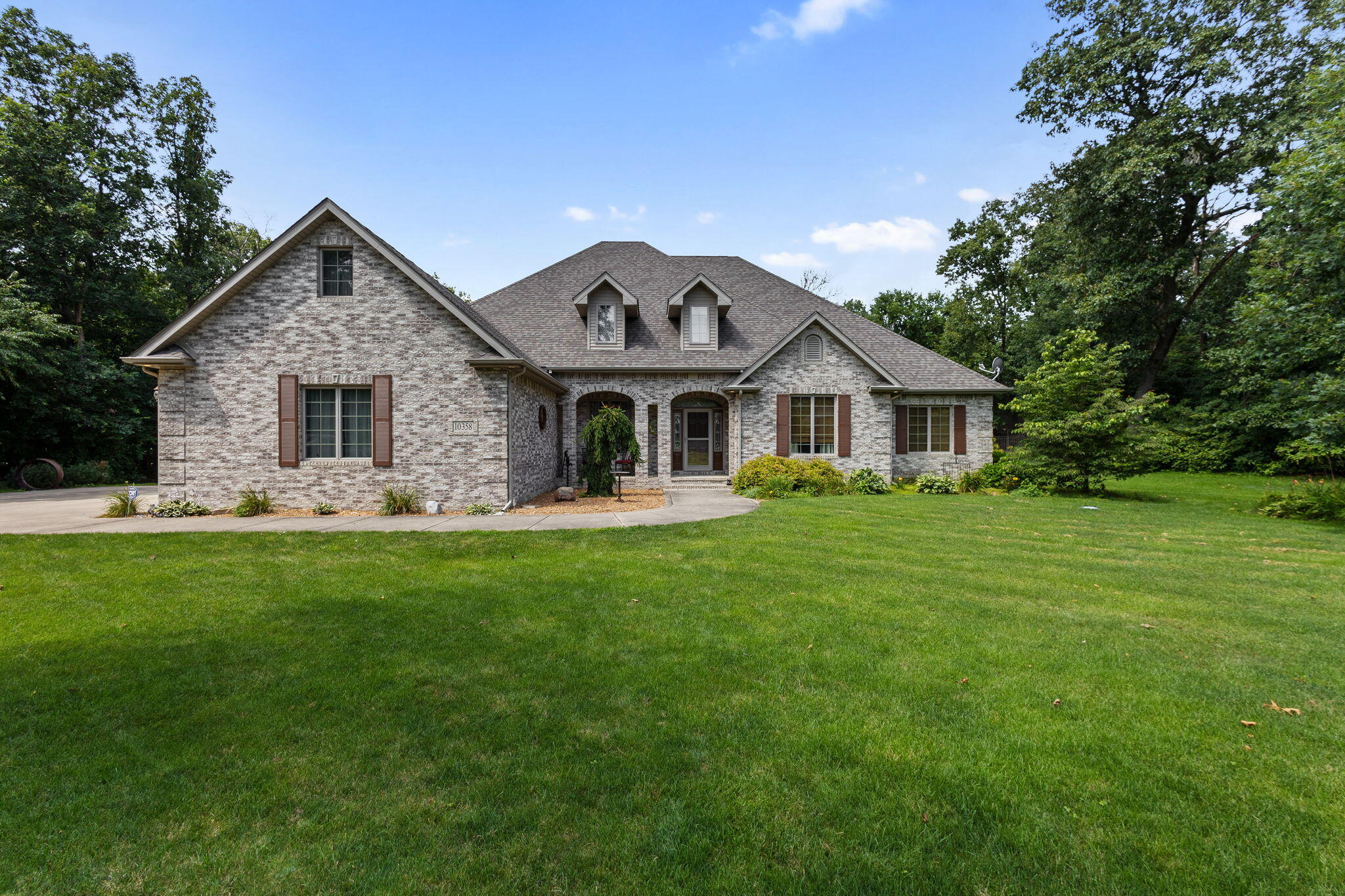 a front view of house with yard and green space