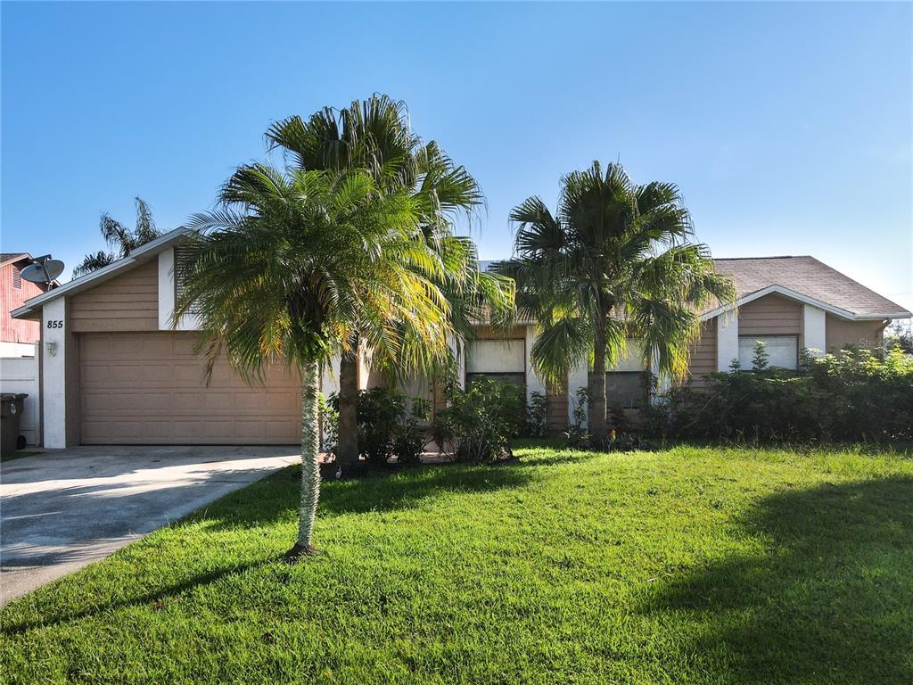 a front view of house and yard with green space