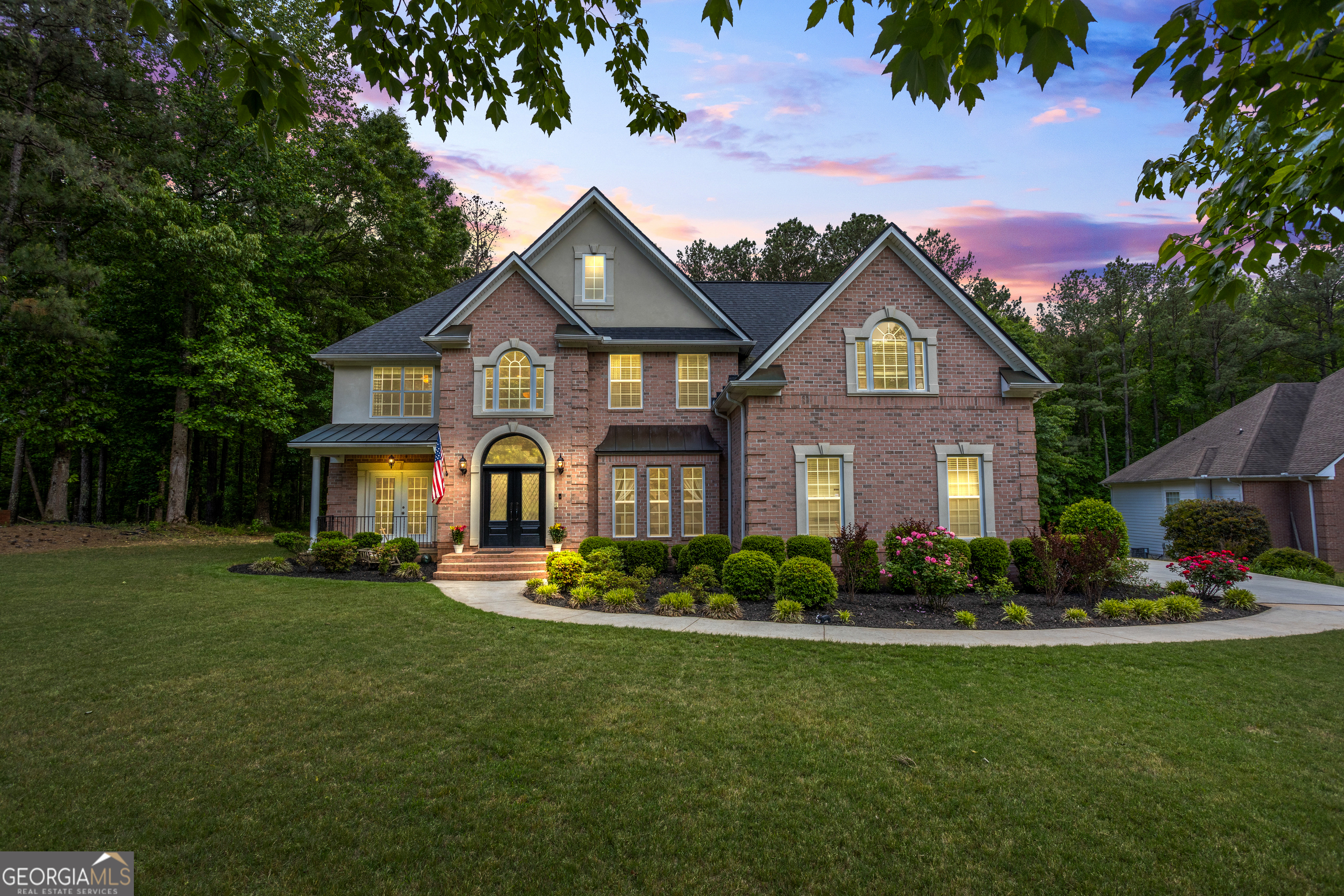 a front view of a house with a garden