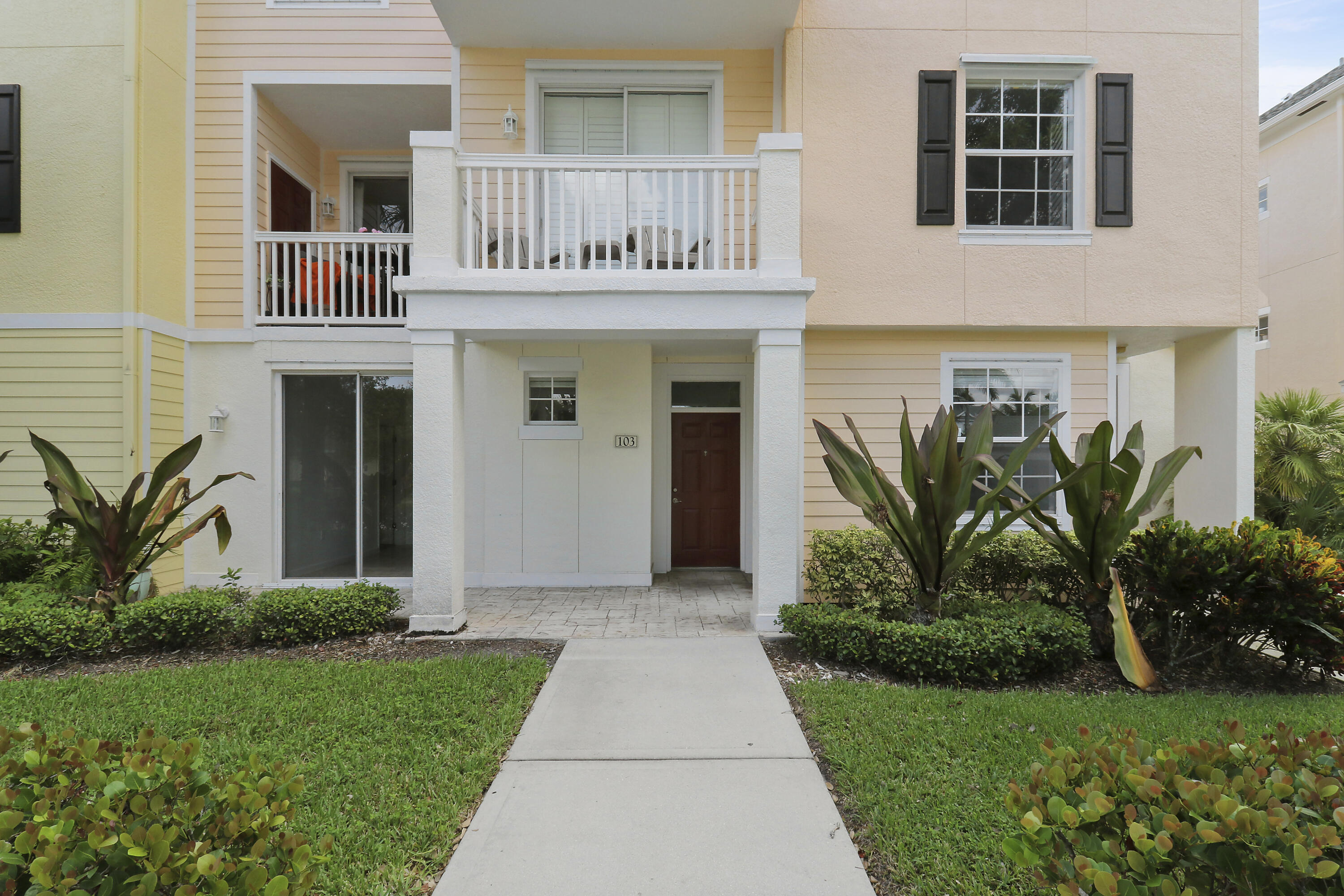 a front view of a house with garden