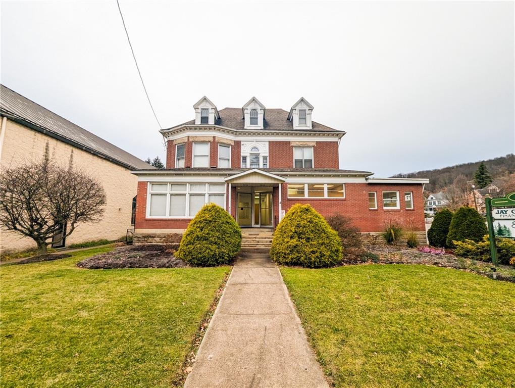 a front view of a house with a yard