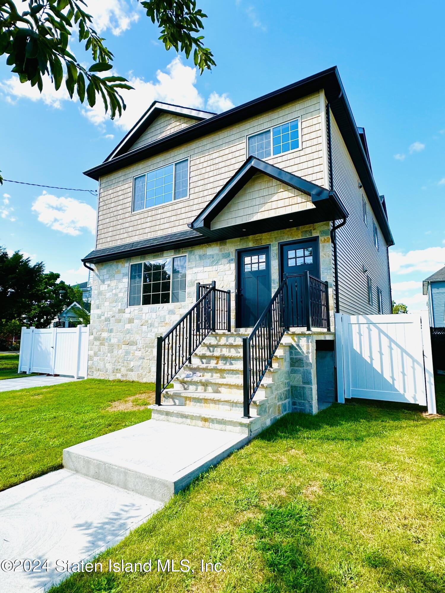 a view of a house with a yard porch and sitting area