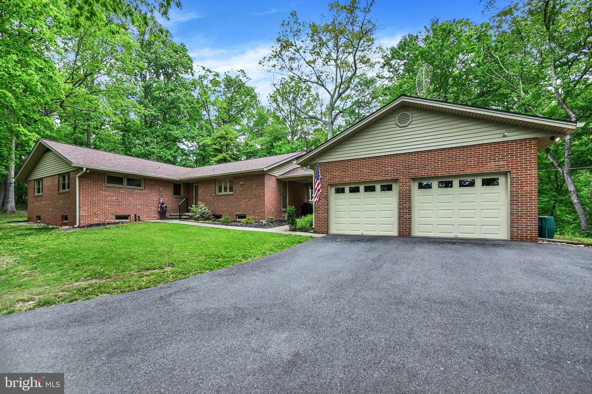 a view of a house with a small yard and garage