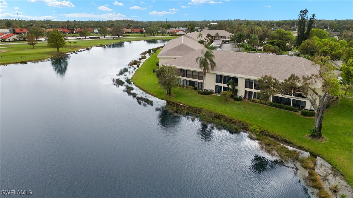 an aerial view of a house with outdoor space and lake view