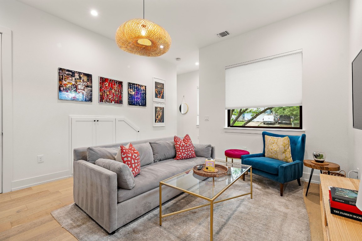 a living room with furniture and a floor to ceiling window