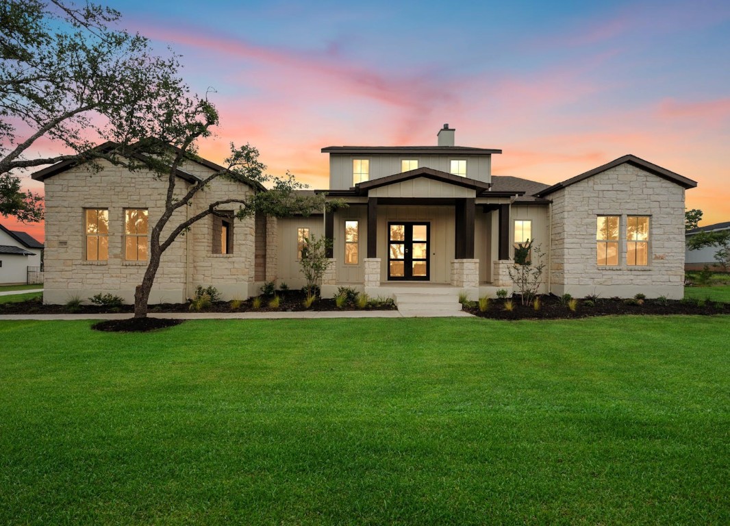 a front view of house with yard and green space