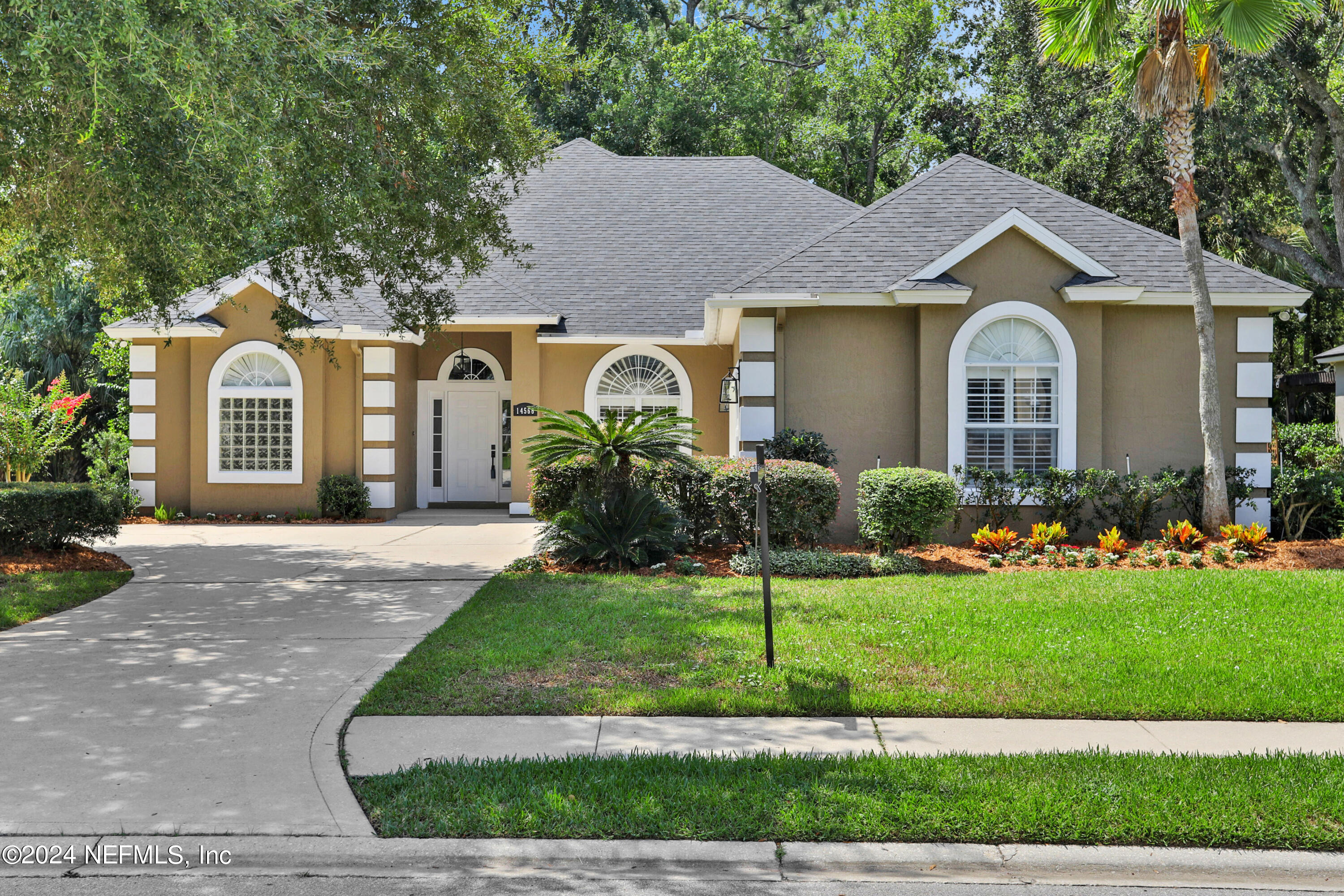 a front view of a house with a garden