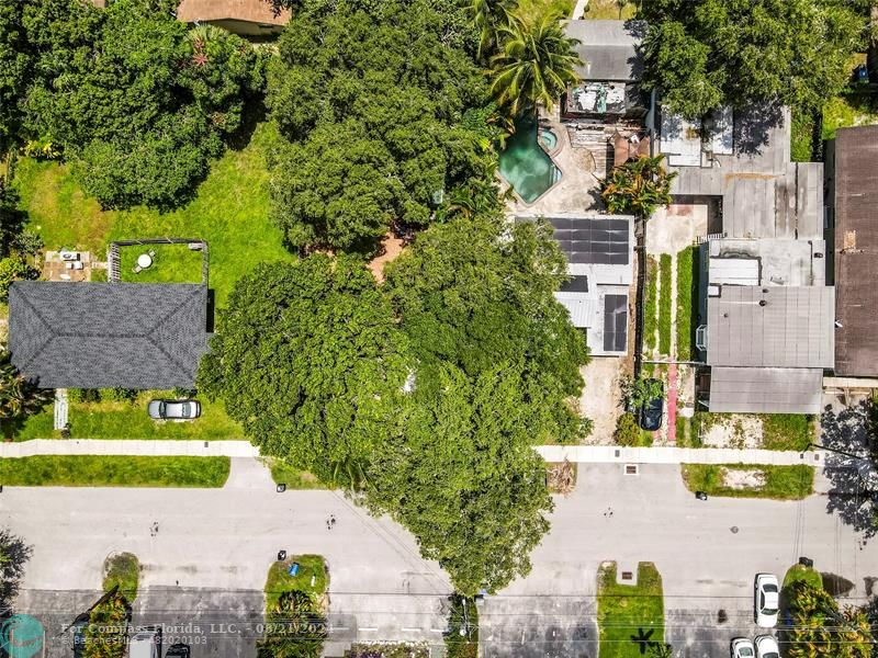 an aerial view of a house with a yard swimming pool outdoor seating and yard